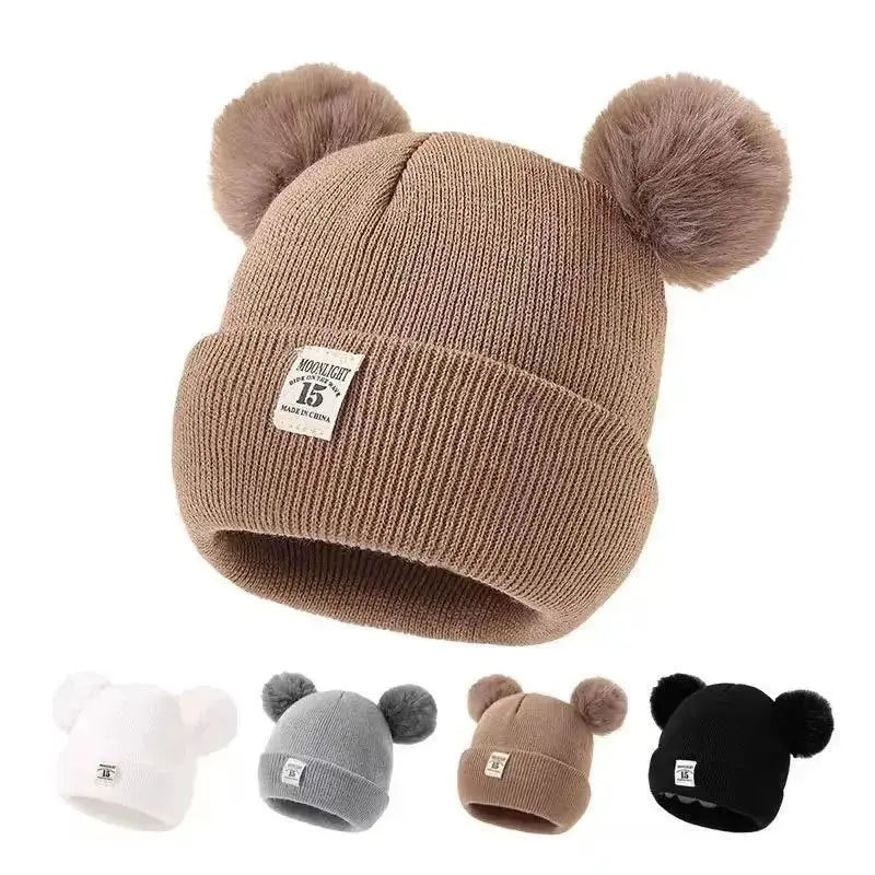 Bonnet à pompons pour bébé - Monde à maman