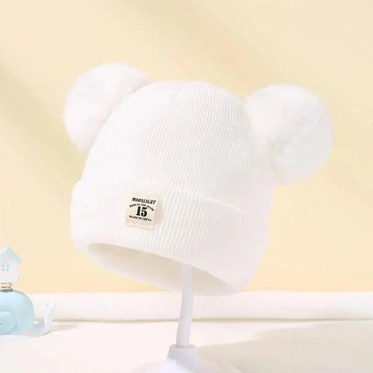 Bonnet à pompons pour bébé - Monde à maman