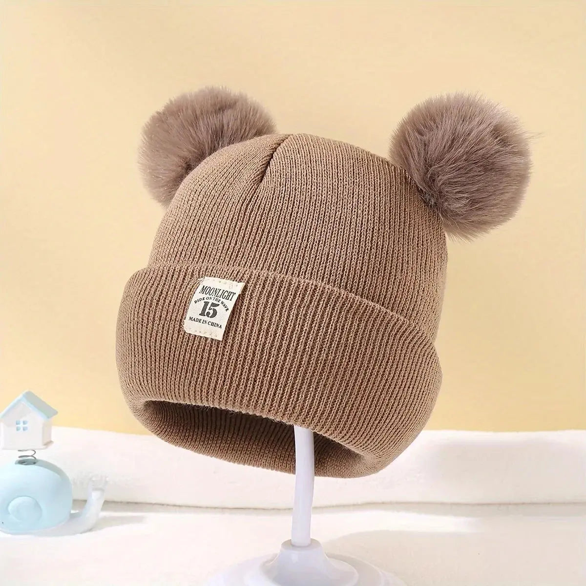 Bonnet à pompons pour bébé - Monde à maman