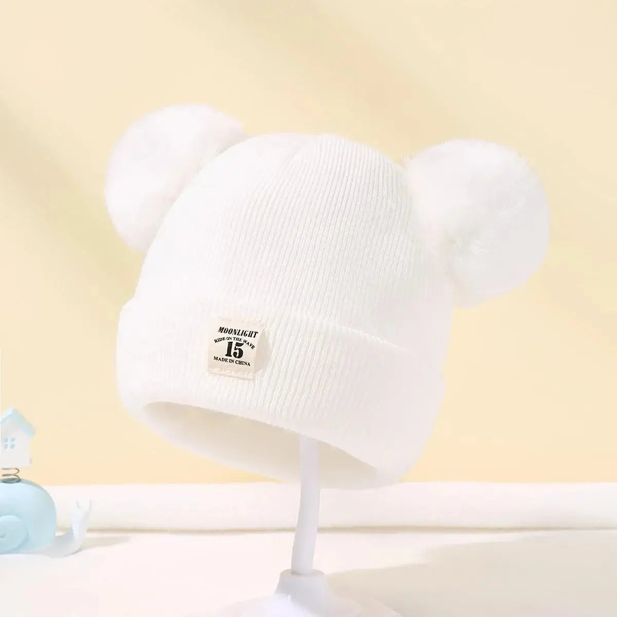 Bonnet à pompons pour bébé - Monde à maman